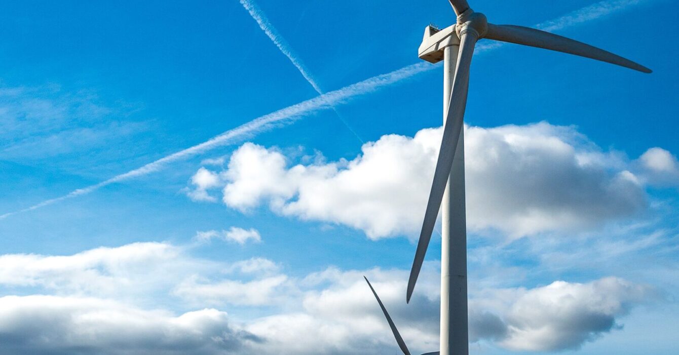 vertical-shot-several-white-electric-windmills-hill